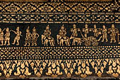 Wat Xieng Thong temple in Luang Prabang, Laos. Detail of the  intricate gold stencilling on black lacquer that decorate the walls of the sim. 